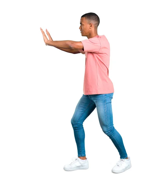 Pie Joven Afroamericano Hombre Empujando Algo Aislado Fondo Blanco —  Fotos de Stock