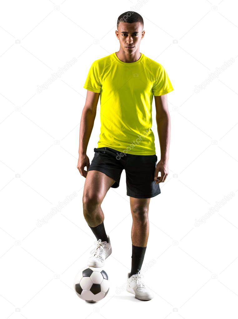 Soccer player man with dark skinned playing on isolated white background