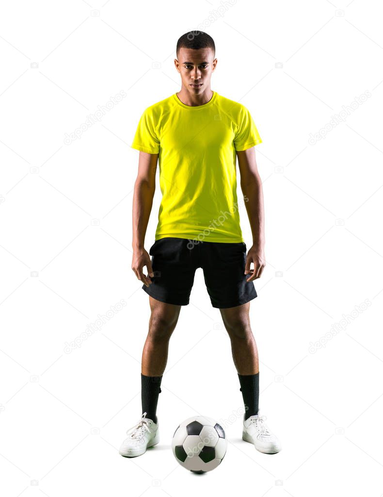 Soccer player man with dark skinned playing on isolated white background