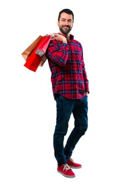 Yakışıklı adam alışveriş torbaları bir sürü holding