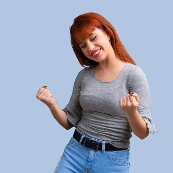 Menina Ruiva Jovem Comemorando Uma Vitória Fundo Azul — Fotografia de Stock