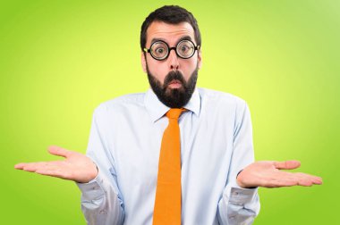 Komik adam gözlüklü renkli arka plan üzerinde önemsiz jest yapma