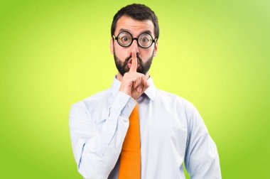 Komik adam ile yapım sessizlik jest renkli arka plan üzerinde gözlük