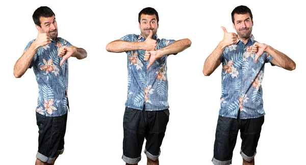 İyi-kötü işaret yapma çiçek forması ile yakışıklı adam kümesi