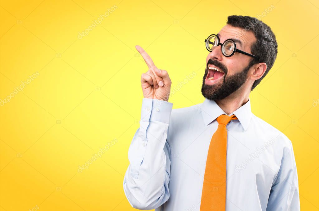 Funny man with glasses thinking on colorful background