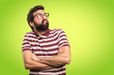 Renkli arka plan üzerinde önemsiz jest yapma gözlüklü adam