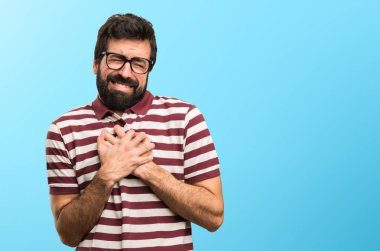 Kalp ağrısı renkli arka plan üzerinde olan gözlüklü adam