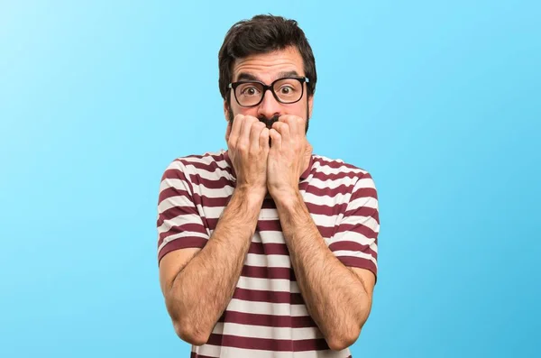 Frightened man with glasses on colorful background