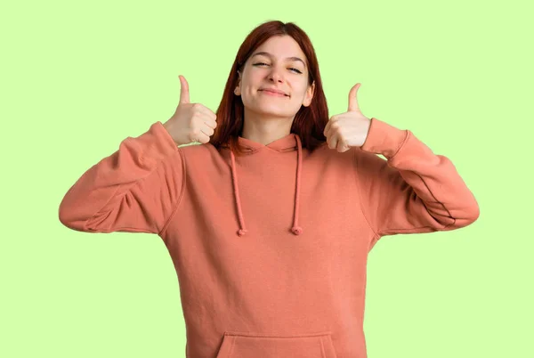 Young Redhead Girl Pink Sweatshirt Giving Thumbs Gesture Smiling Because — Stock Photo, Image