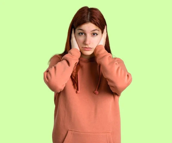 Young Redhead Girl Pink Sweatshirt Covering Both Ears Hands Frustrated — Stock Photo, Image