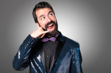 Payet ceket gri arka plan üzerinde yapım telefon hareketi ile yakışıklı adam