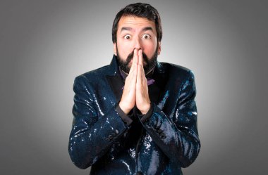 Payet ceket gri arka plan üzerinde yalvaran ile yakışıklı adam