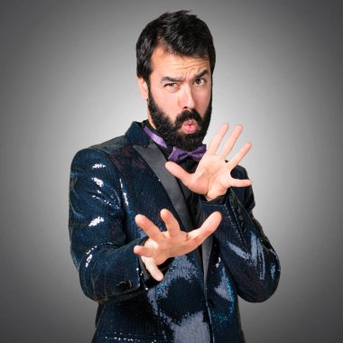 Payet ceket gri arka plan üzerinde korkmuş yakışıklı adam