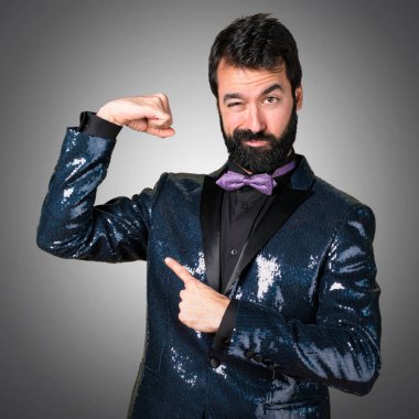 Payet ceket gri arka plan üzerinde güçlü bir jest yapma ile yakışıklı adam