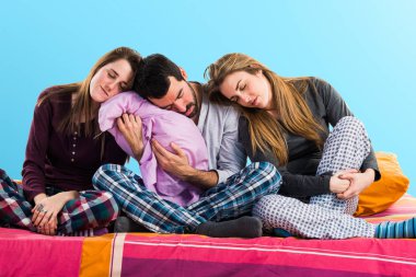 Bir yatakta uyuyan üzerinde üç arkadaş