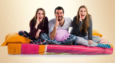 Üç arkadaş bir yatak bağırarak üzerinde