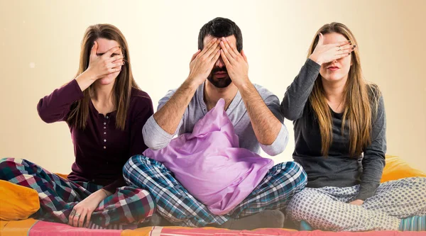 Gözlerini kapsayan bir yatakta üç arkadaş
