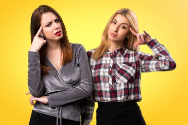 İki arkadaş renkli arka plan üzerinde deli jest yapma