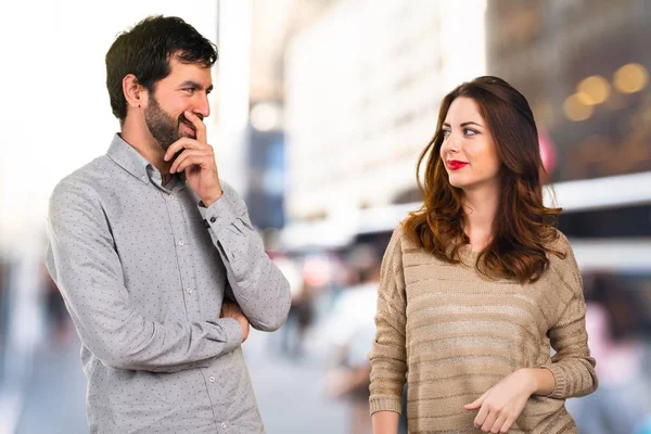 Young couple thinking on unfocused background