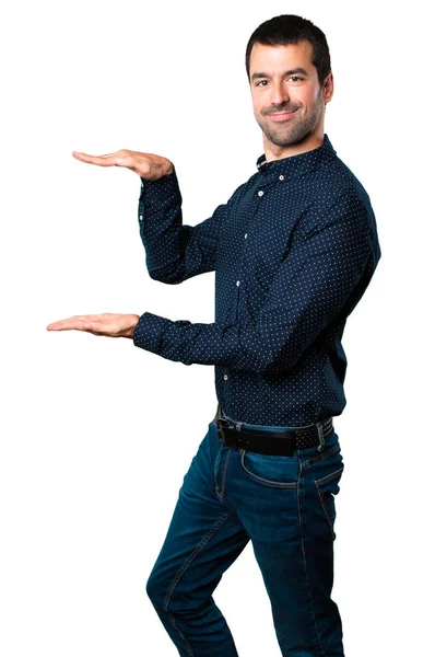 Hombre Guapo Sosteniendo Algo Sobre Fondo Blanco Aislado —  Fotos de Stock