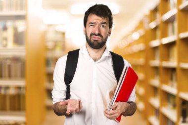 Ufuk kitaplığını yorgun öğrenci adam