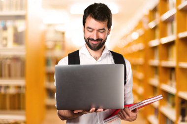 Ufuk kütüphane üstünde laptop ile öğrenci adam