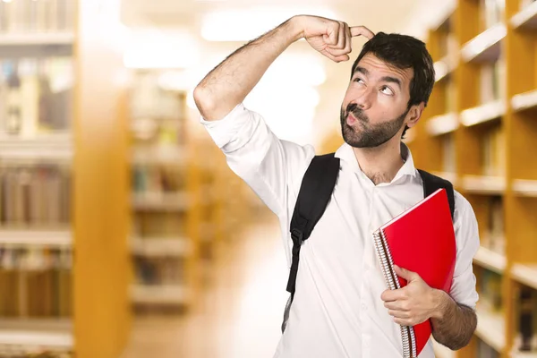 Student Man Having Doubts Defocused Library — Stock Photo, Image