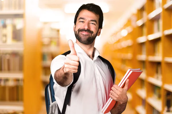 Estudante Com Polegar Para Cima Biblioteca Desfocada — Fotografia de Stock