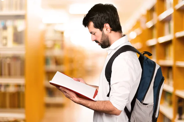 Student Man Reading Defocused Library — Stock Photo, Image