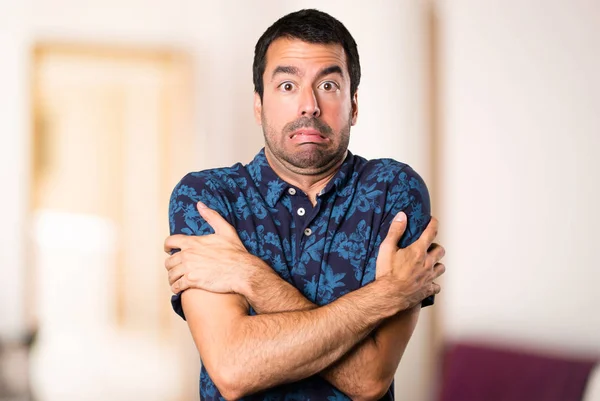 Freezing brunette man inside room