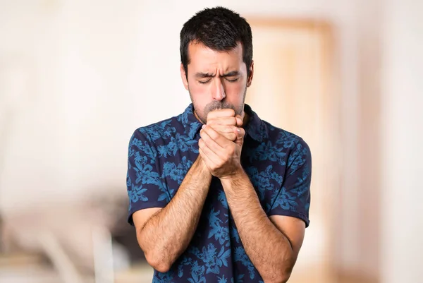 Brunette man coughing a lot inside room