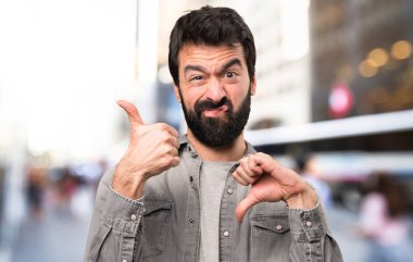 İyi-kötü işareti, açık hale sakallı yakışıklı adam