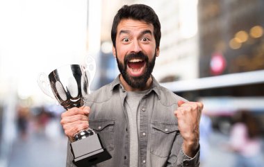 Bir kupa, açık tutarak sakallı yakışıklı adam