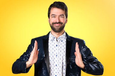 Adam bir şey renkli arka plan üzerinde tutan ceket ile