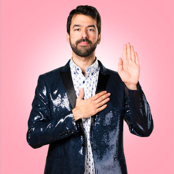 Man with jacket making an oath on colorful background