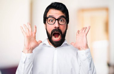 Yakışıklı adamla yapım sürpriz jest odaklanmamış arka plan üzerinde gözlük