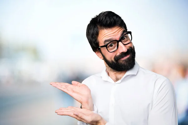 Handsome Man Glasses Presenting Something Unfocused Background — Stock Photo, Image