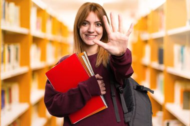 Öğrenci kadın beş odaklanmamış arka plan üzerinde sayma