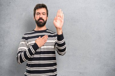 Man with beard making an oath on textured background clipart