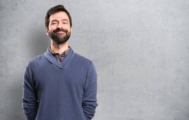 Dokulu arka plan üzerinde sakallı mutlu yakışıklı esmer adam