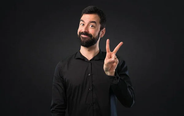 Schöner Mann Mit Bart Macht Siegesgeste Auf Schwarzem Hintergrund — Stockfoto