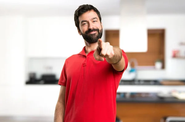 Handsome man pointing to the front inside house