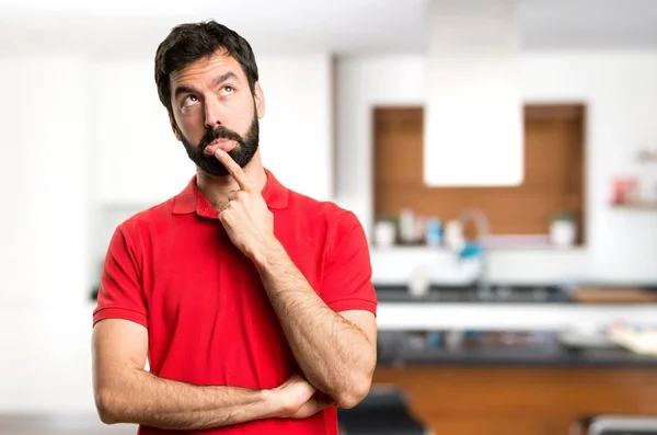 Handsome man having doubts inside house