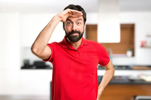 Handsome man showing something inside house