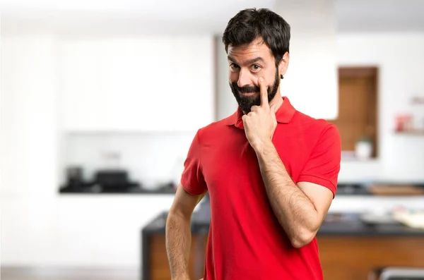 Handsome man showing something inside house