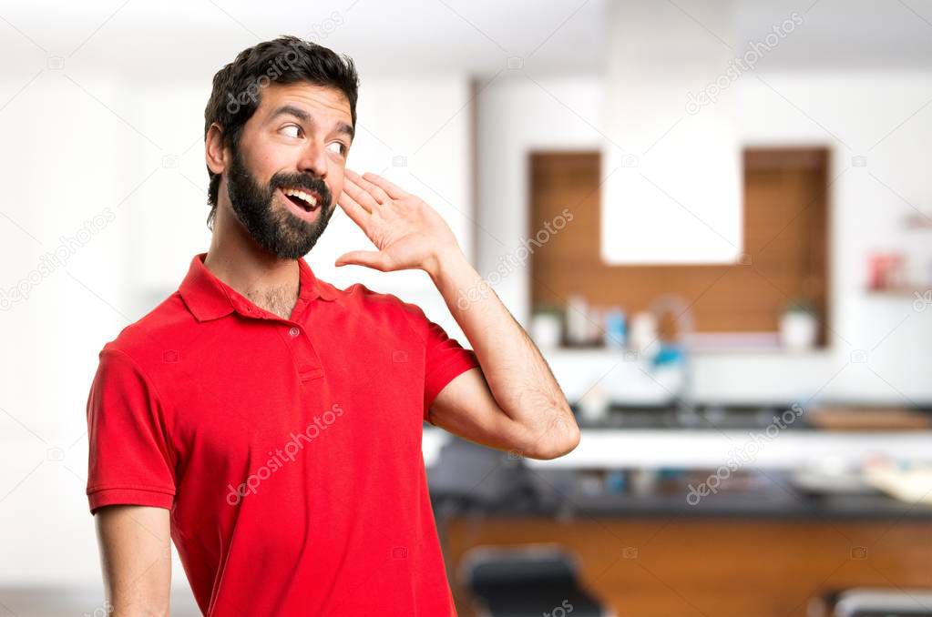 Handsome man listening something inside house