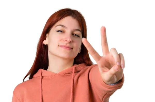 Young Redhead Girl Pink Sweatshirt Smiling Showing Victory Sign Isolated — Stock Photo, Image