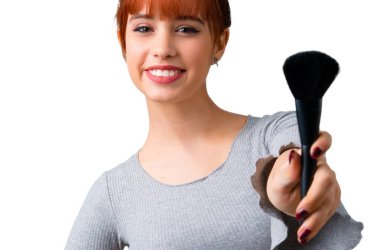 Genç Kızıl saçlı kız makyaj fırçası ile