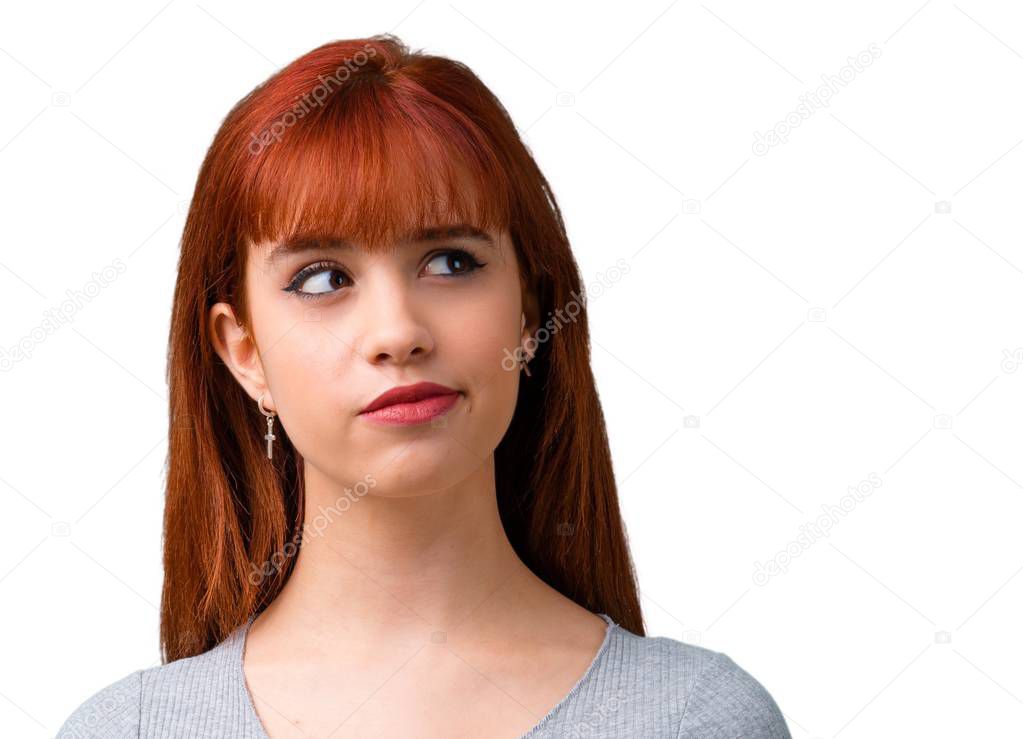 Young redhead girl having doubts and with confuse face expression