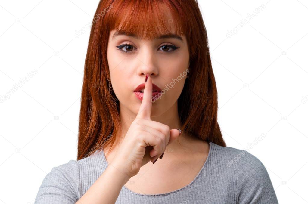 Young redhead girl showing a sign of closing mouth and silence gesture